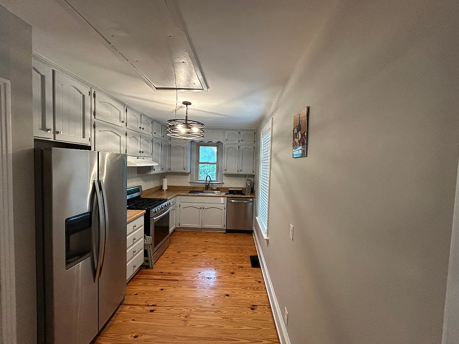 The kitchen blends classic home charm with modern convenience, featuring stainless steel appliances, a gas stove, and a functional layout that makes cooking and meal prep easy. Its a great space for guests who enjoy preparing meals at home while still being close to Midtown restaurants, coffee shops, and grocery stores.