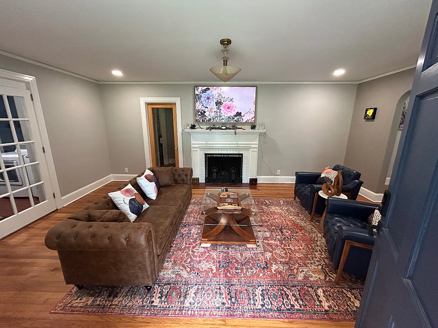 Welcome! You are greeted with the living room. It is designed with a warm mid-century modern feel, blending clean lines, comfortable seating, and stylish dcor to create a space that feels both relaxed and thoughtfully put together. Its a great spot to unwind after work, enjoy the TV, read, or settle in for a quiet evening at home.