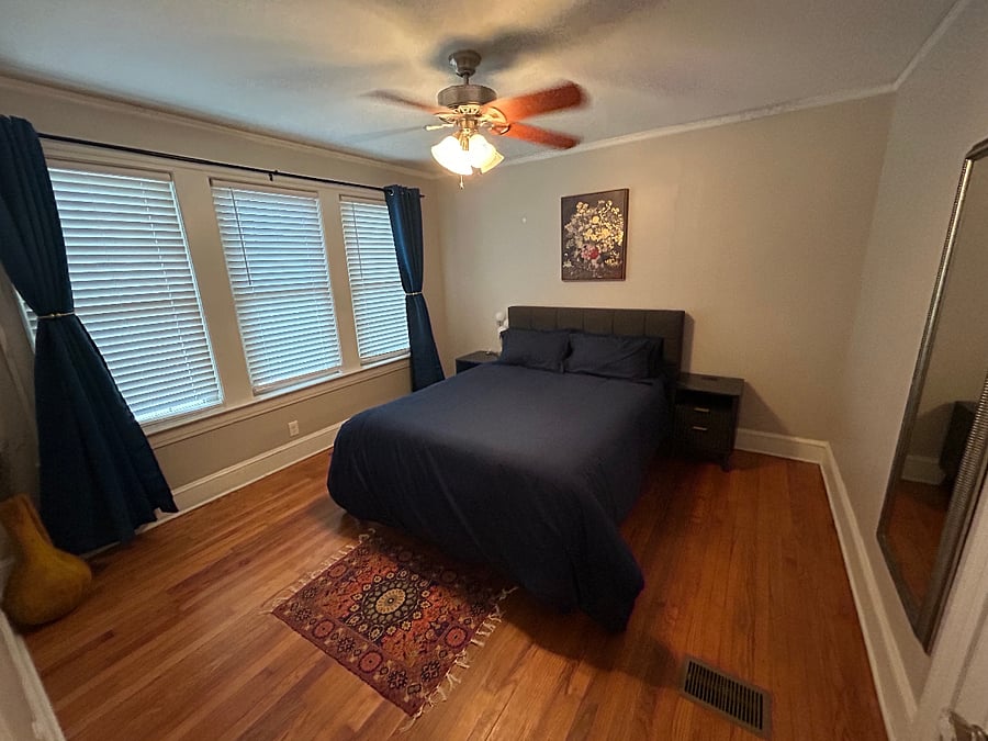 Bedroom 1 is bright, cozy, and thoughtfully designed with three windows, blackout curtains, closet space, and a stylish gold mirror. Enjoy natural light during the day and restful privacy at night the perfect setup for traveling professionals who want a comfortable place to relax and recharge.