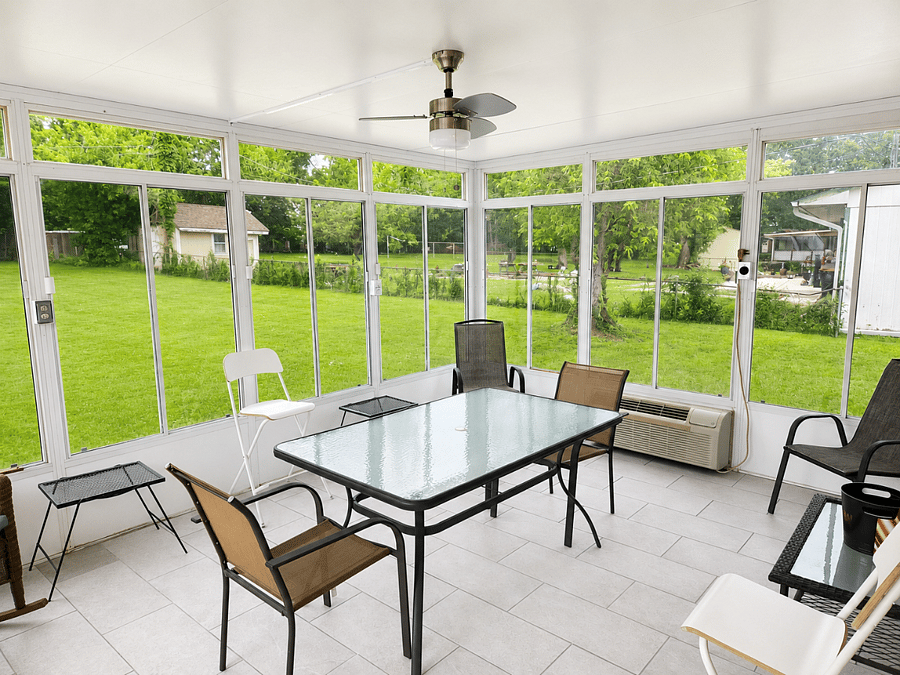 Spacious screened-in patio with outdoor dining and relaxing seating area