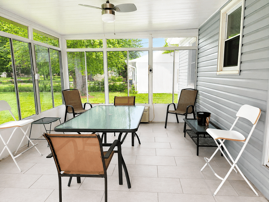 Enjoy morning coffee or evening conversations in this airy enclosed patio