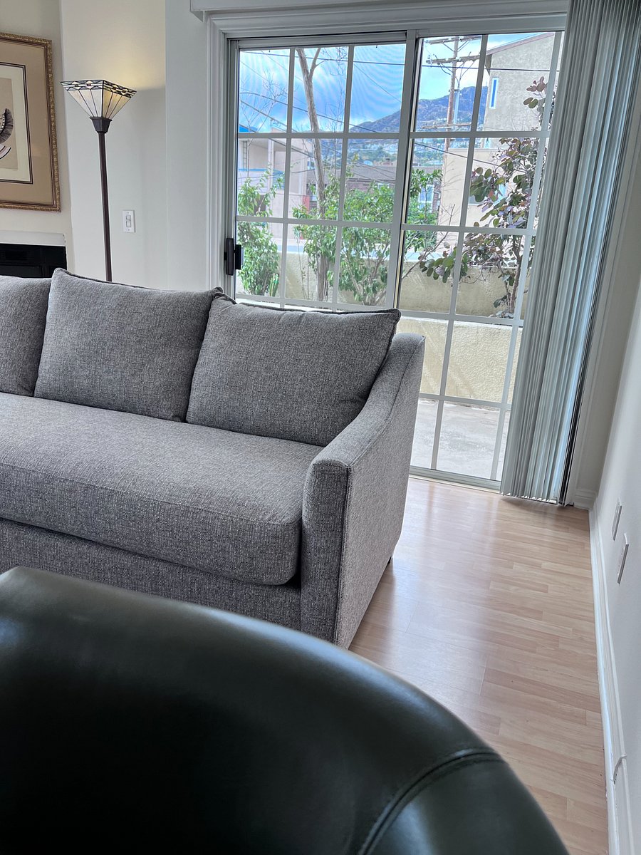 Living room sliding door with access to common potdoor areas.  Can furnish with outdoor furniture.