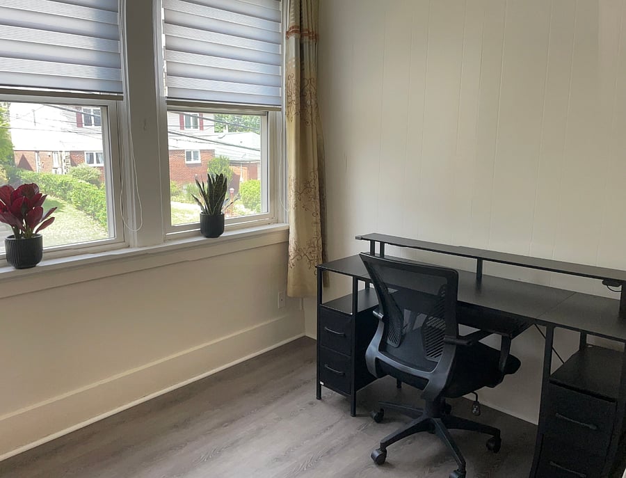 Bright sun room with desk and chair - perfect workspace for remote work