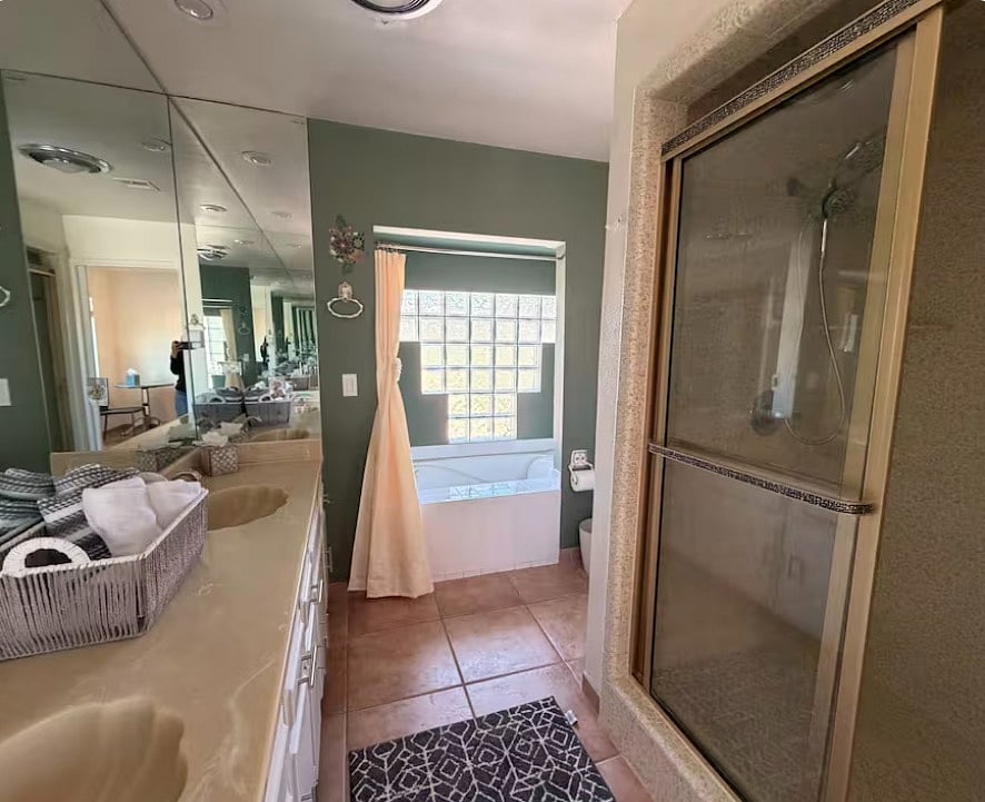 Primary Bathroom with two sinks, tub and shower