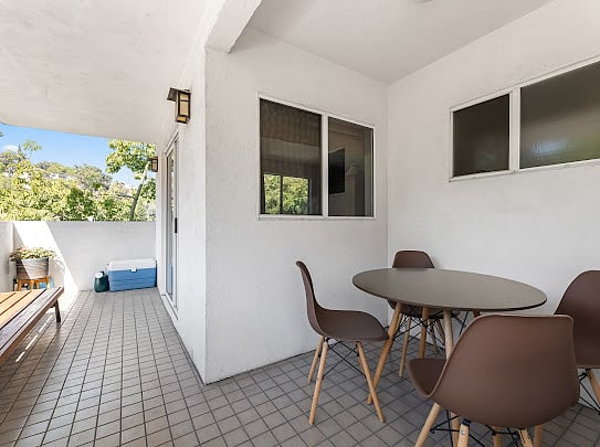 Covered patio off the dining room with outdoor dining for four, protected from weather.
