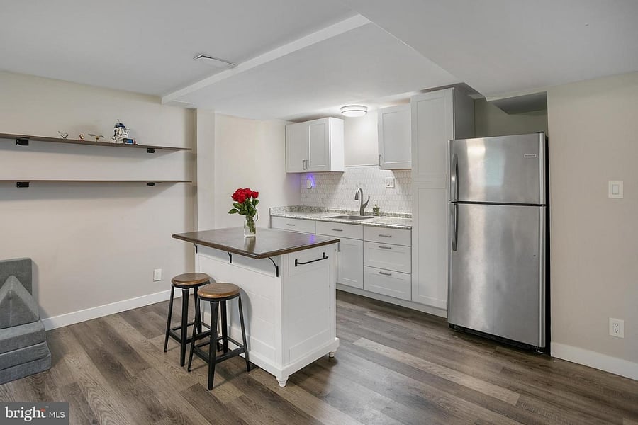 Kitchenette with stools, full sized refrigerator, and lots of cabinet space. 