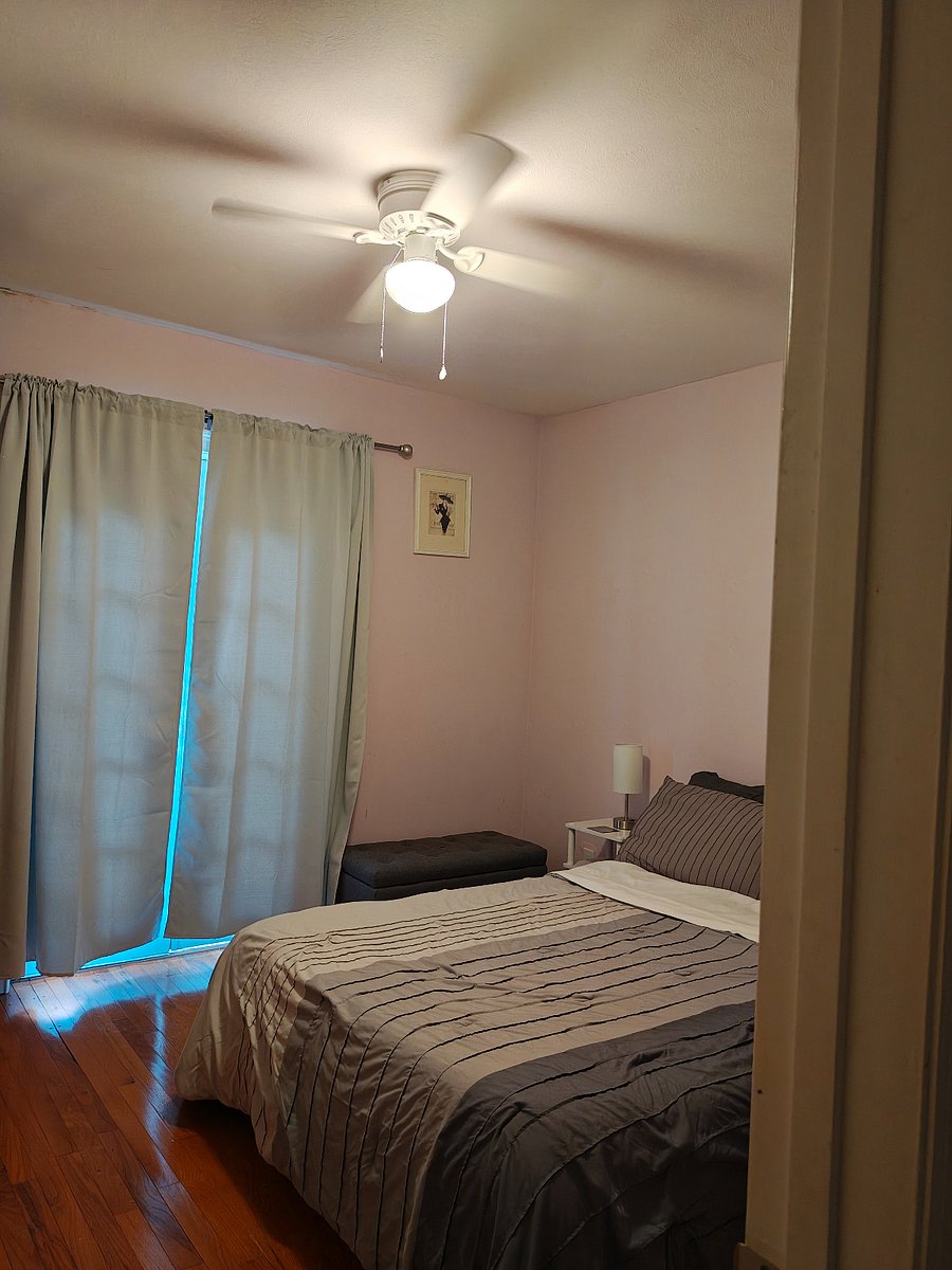 Room darkening curtains on French doors which open to the deck.