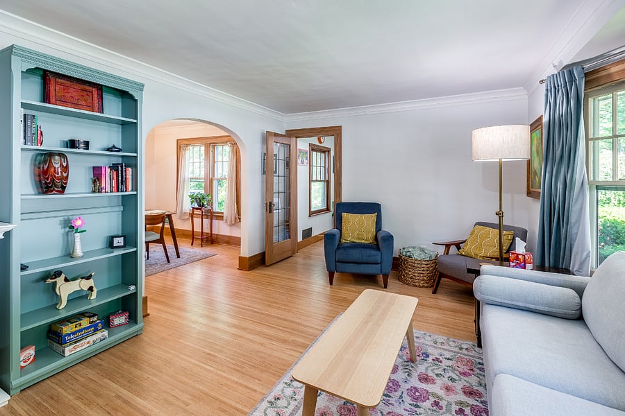 Living room with built-in bookshelves, smart TV, and electric fireplace