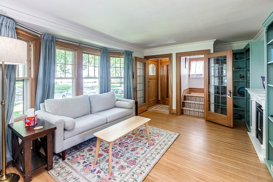 Living room with built-in bookshelves, smart TV, and electric fireplace