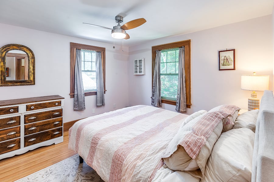 Bedroom with queen bed, mirror, nightstand, closet, and dresser