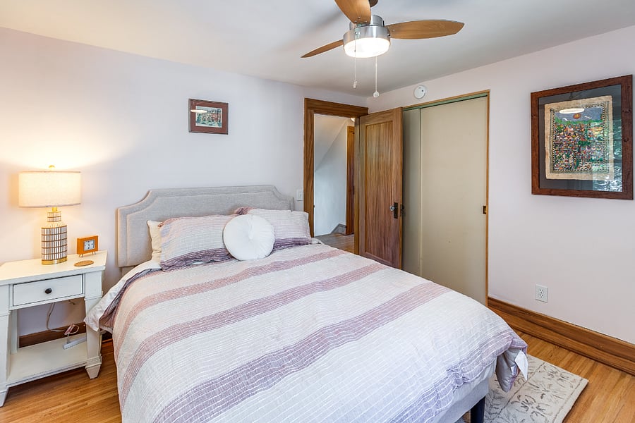 Bedroom with queen bed, mirror, nightstand, closet, and dresser