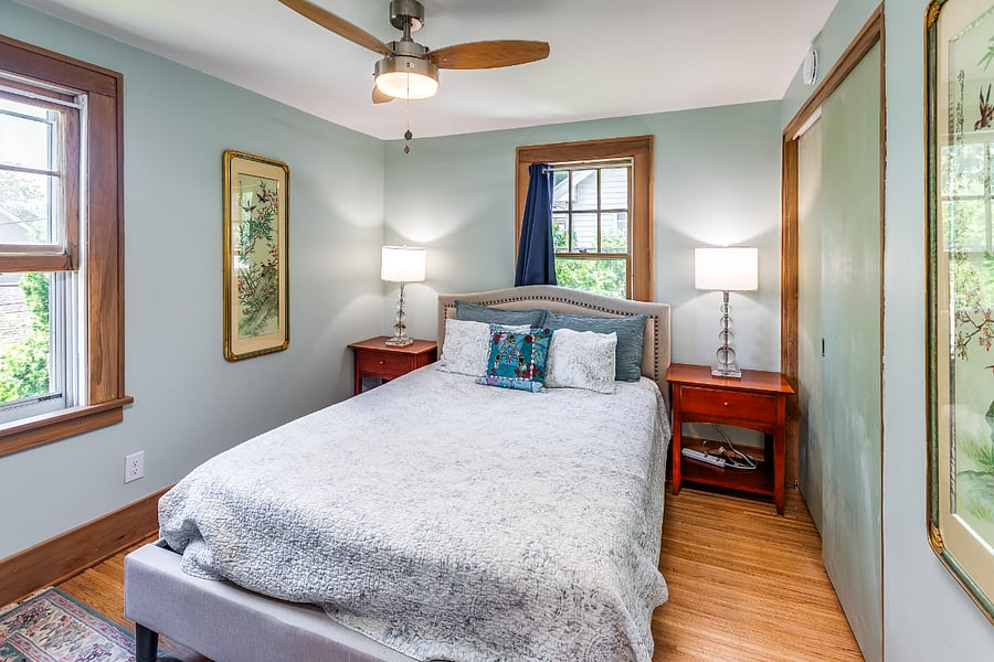 Bedroom with queen bed, mirror, nightstands, closet, and dresser