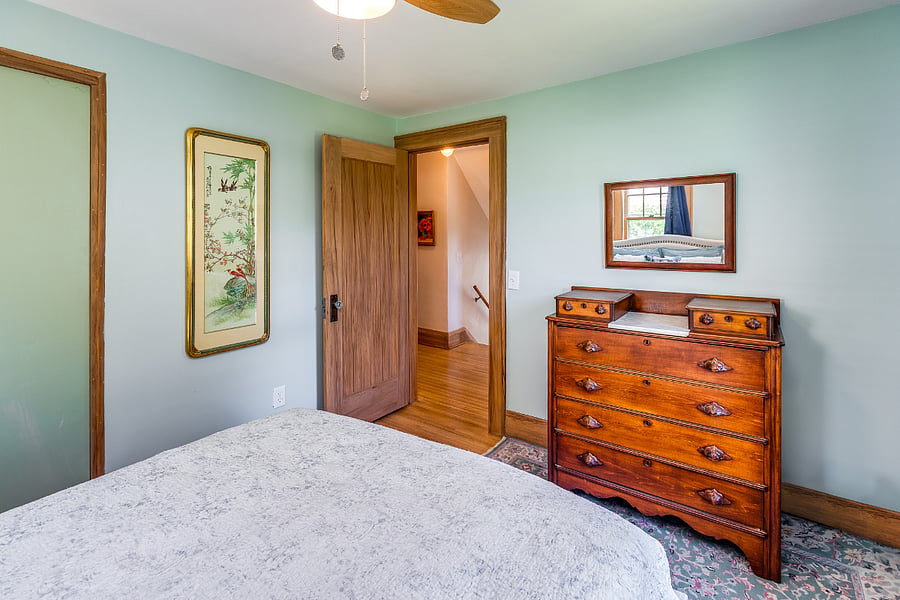 Bedroom with queen bed, mirror, nightstands, closet, and dresser
