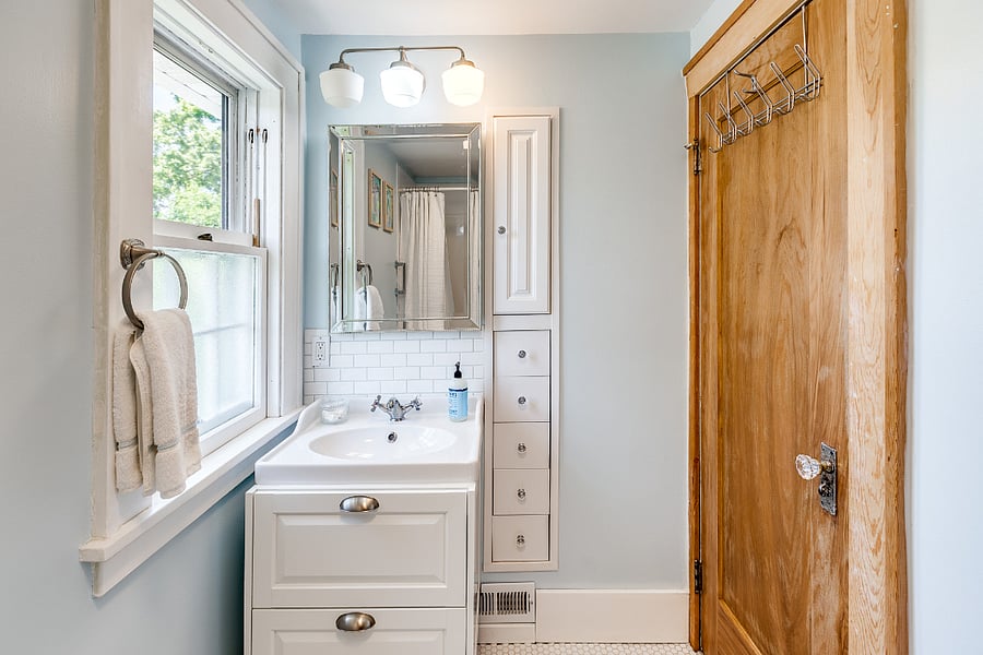 The full bathroom features a built-in cabinet and drawer set, perfect for organizing toiletries