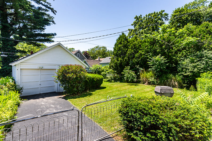 Private backyard with 1-car garage, shed, and an in-ground charcoal grill