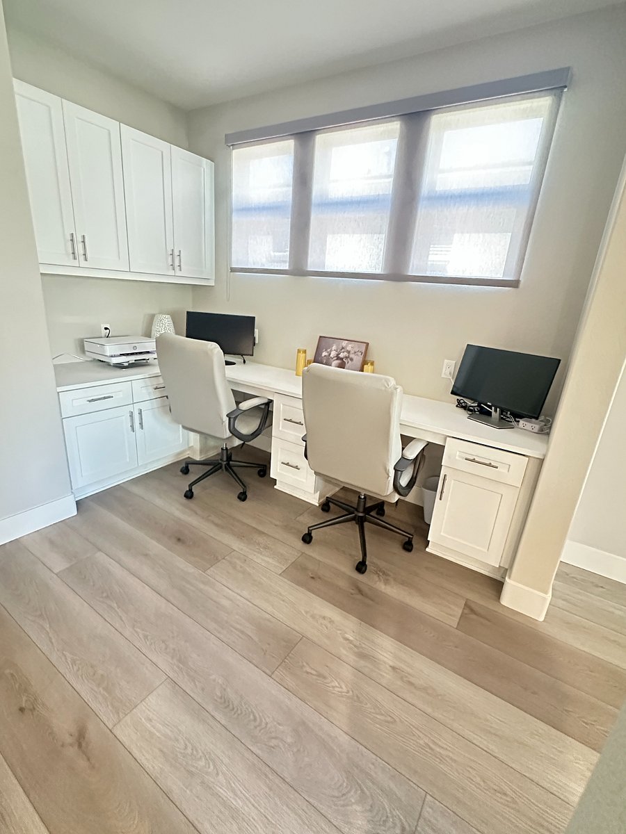 Office with double desks, monitors and printer