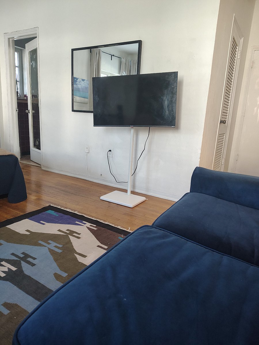 TV swivels and you can watch from the sofa and from the bed.