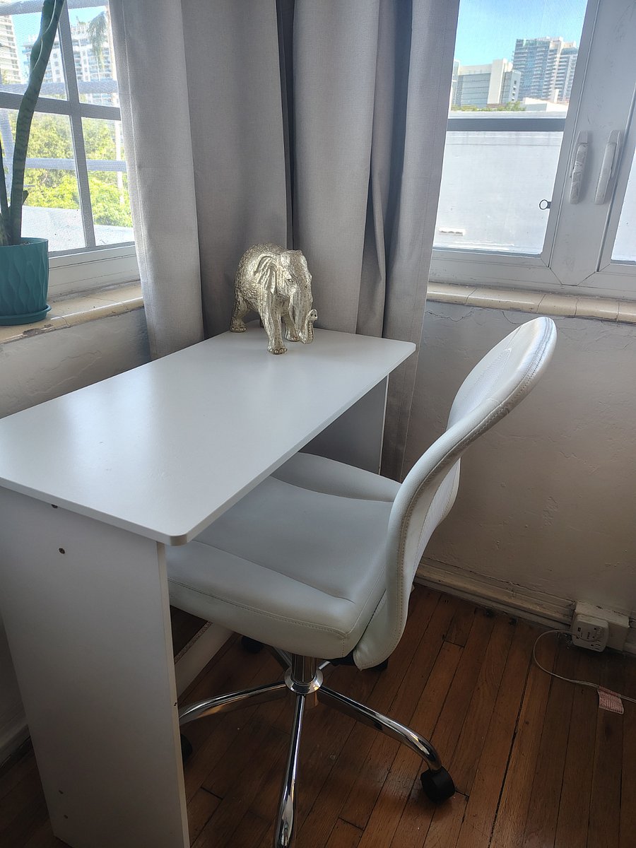 Comfortable work station with a really beautiful view towards collins avenue and the ocean. You can see the hotel buildings on the beach.