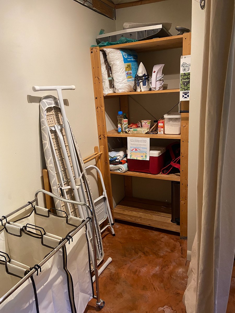 Pantry (shelves will be cleared off for your use). located across from washing machine and dryer and before entrance to kitchen. Includes 3 bag rolling laundry sorter cart, ironing board, iron and retractable clothes line with clothespins to hang delicates. 