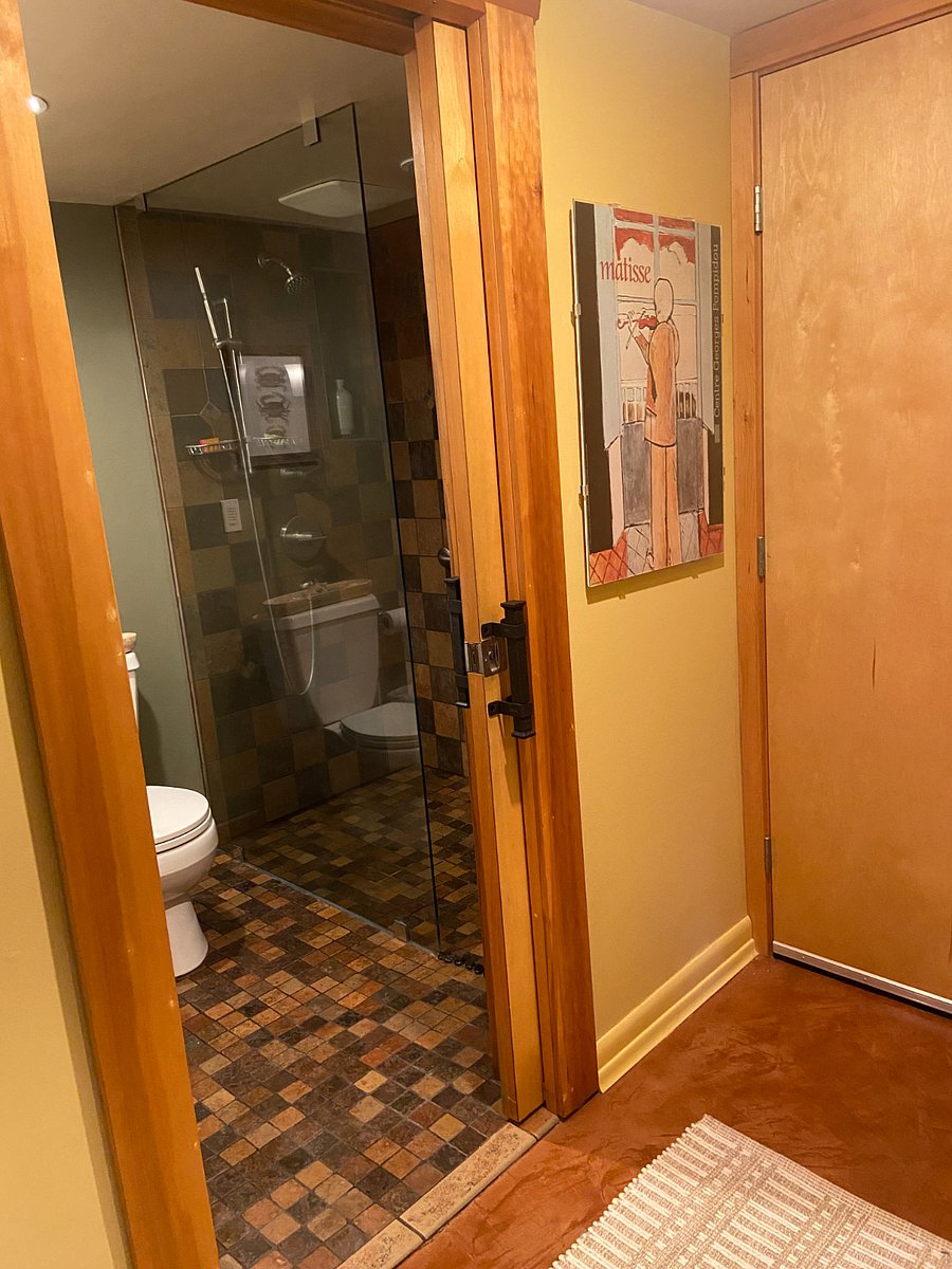 hallway view of bathroom with pocket door (open)