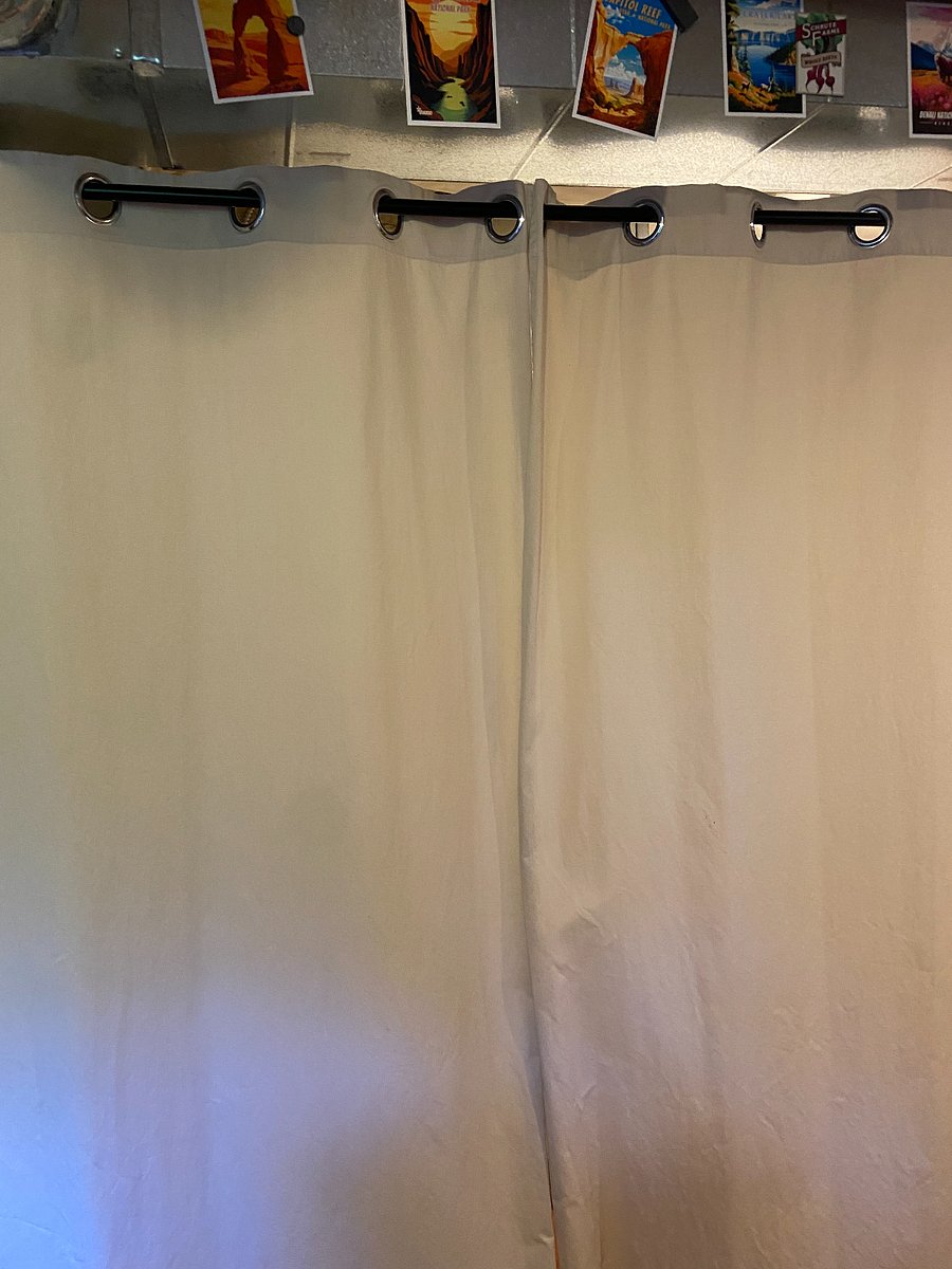 Curtains that close off pantry and laundry items. 