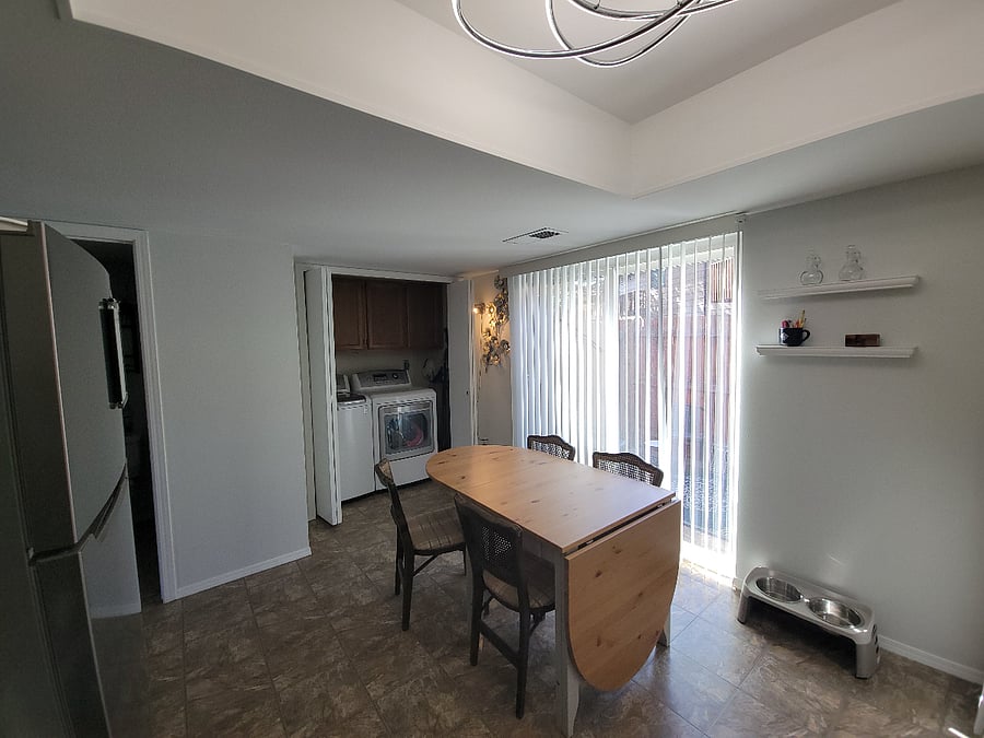 Eat-in kitchen, full size washer & dryer behind doors that close.