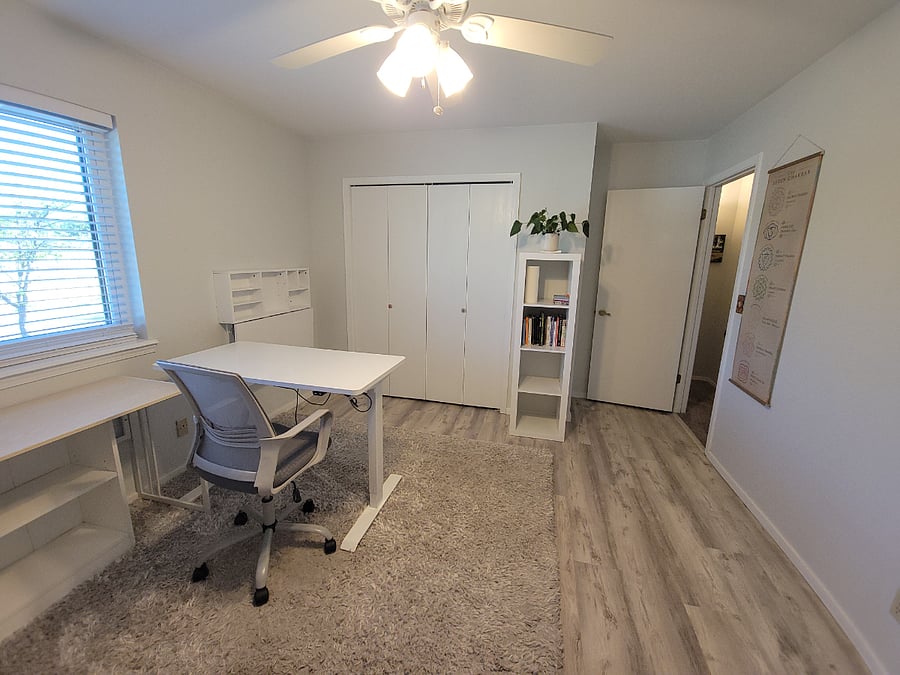 Spacious office with electric desk that rises.