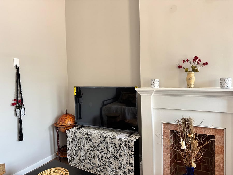 Living room with large screen Smart TV and coffee table that transforms into a raised desk workspace