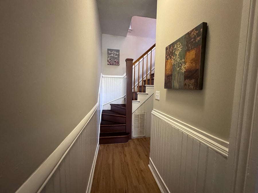 Downstairs foyer leading to staircase and kitchen