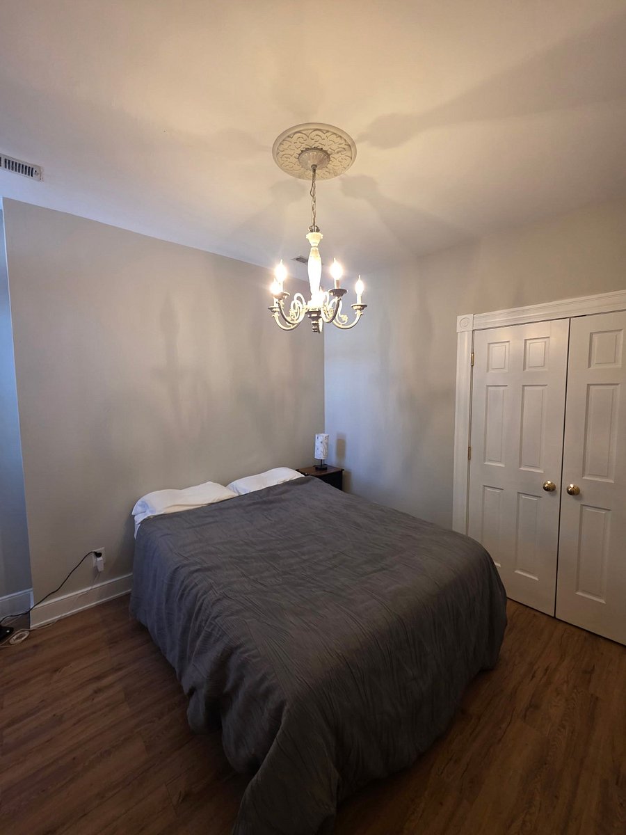 This fourth bedroom upstairs has a full closet and a lovely chandelier.  It also has a door to the fire escape - a full metal staircase.