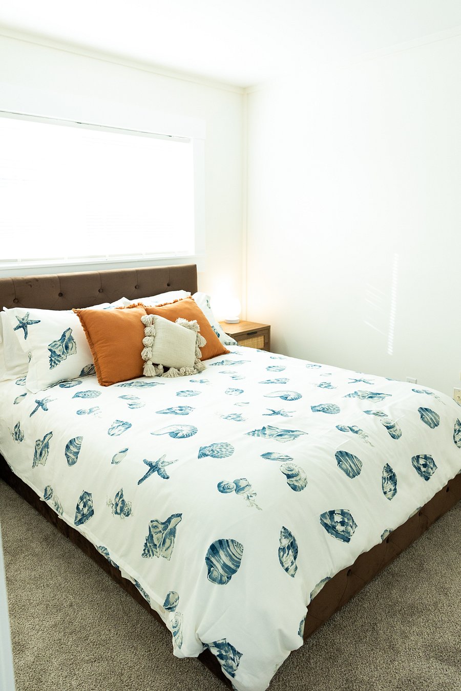 Bedroom #1 - queen size bed, has an AC split unit and carpet.
4 storage drawers underneath bed and an armoire with hangers and shelves.