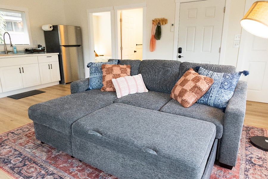 Couch pulls out to larger size. Storage area underneath left side of couch. 