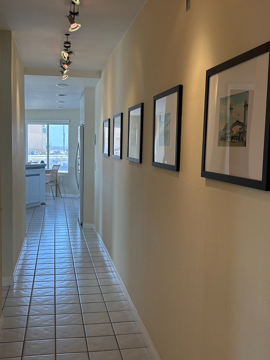 Entry hallway with framed photos of Ocean Beach