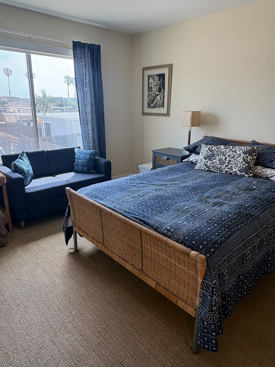 Large master bedroom has cozy sitting area