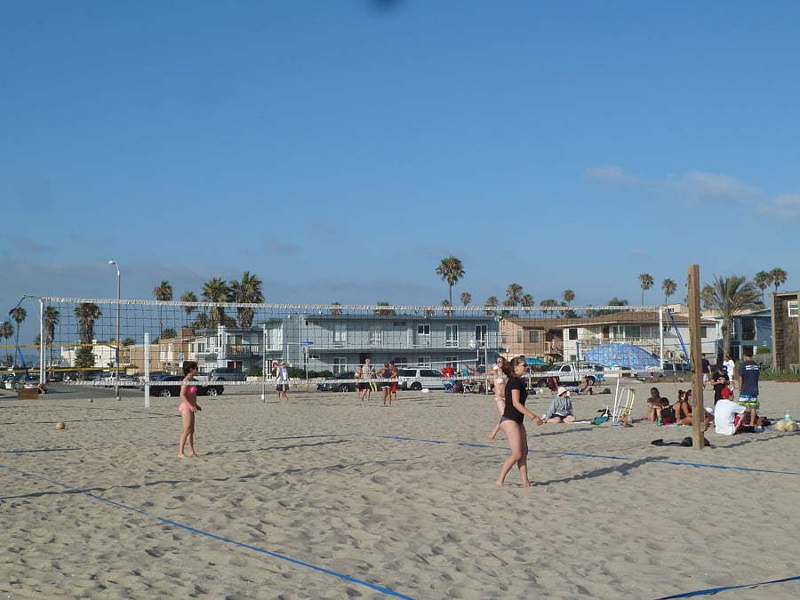 Take a few minutes on your beach walk to enjoy the beach volley ball games
