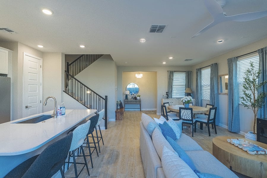 Beautiful open-floor plan with modern kitchen, dining area, and designer staircaseclean and airy