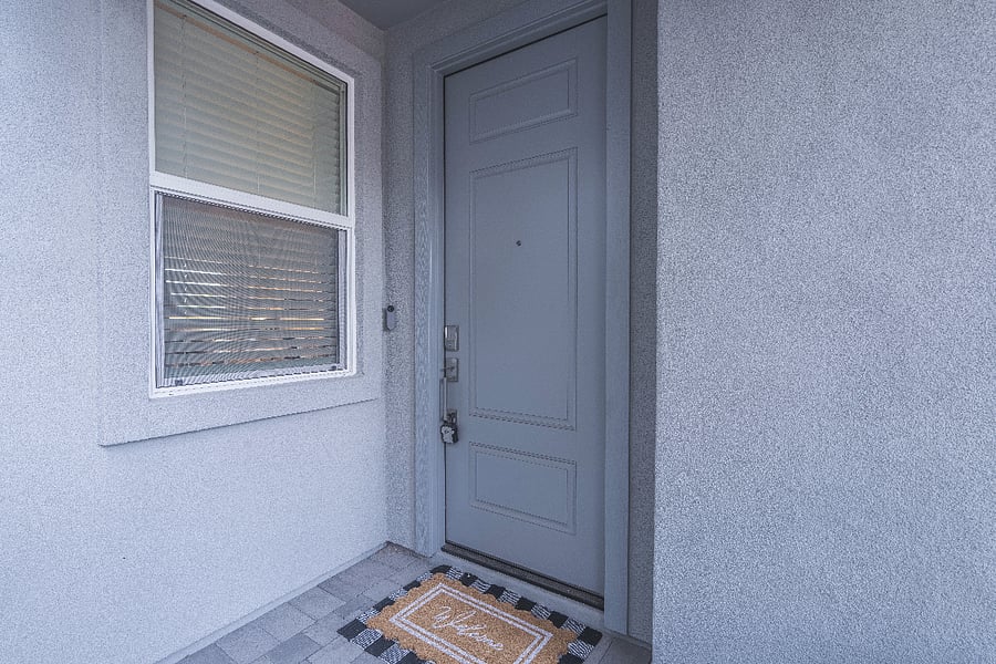 Contemporary Phoenix rental with a private garage, cozy front entry, and charming welcome mat.