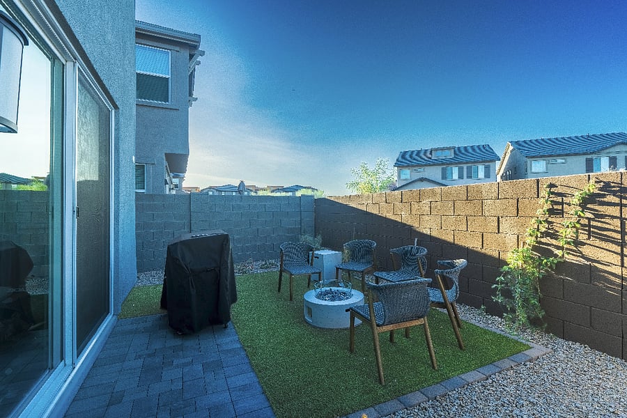 Private backyard with gas grill, turf seating area, and fire pitideal outdoor space for guests to enjoy.