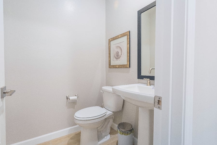 Bright and modern half bath on the main level perfect for quick freshening up and added convenience during your stay.
