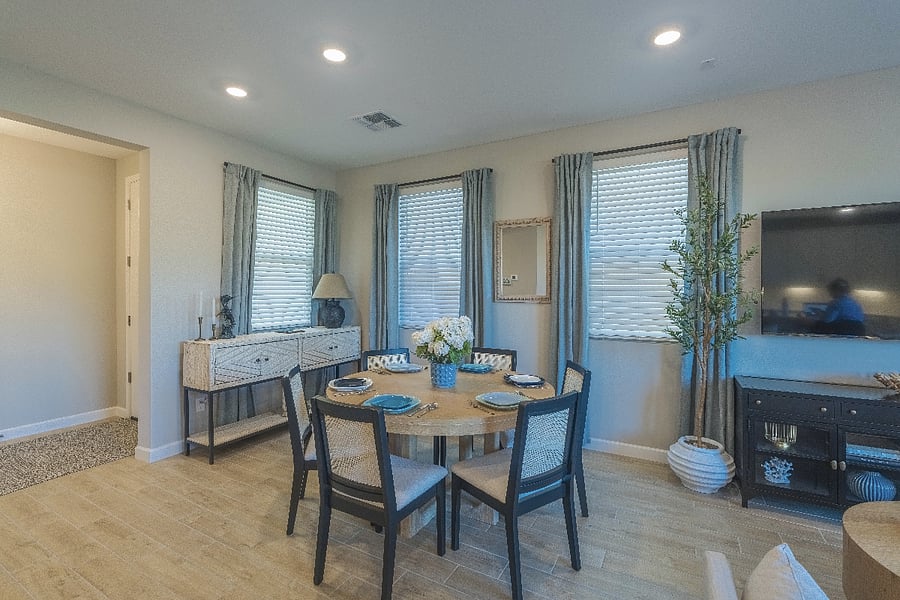 Bright and inviting dining area with modern decor, large windows, and open-concept flow into the living room.