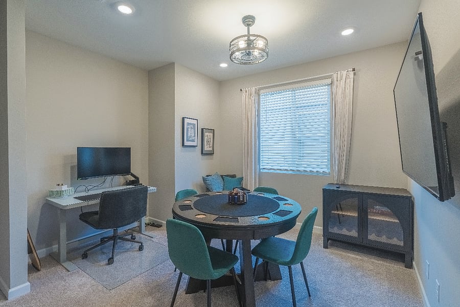 Versatile loft with a dedicated workspace, game table, and large smart TV perfect for working remotely or relaxing with friends and family.