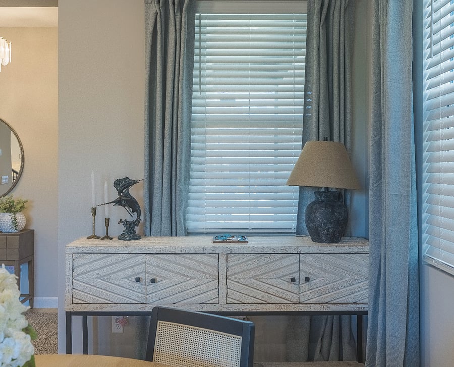Stylish dining room sideboard with textured wood design, elegant decor, and natural lighting.