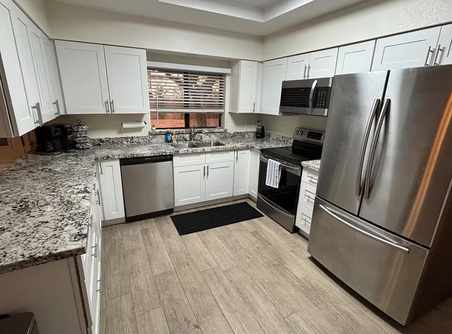 Fully stocked kitchen, with stainless steel appliances, coffee bar, and walk-in pantry.