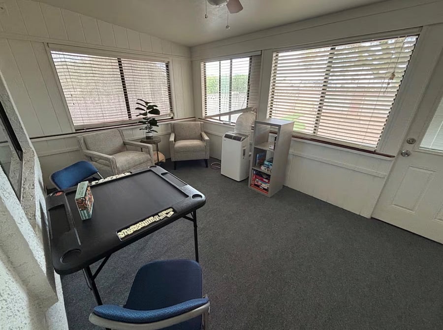 Arizona room with comfy seating, game table, and puzzles, books and games to enjoy and make memories with.