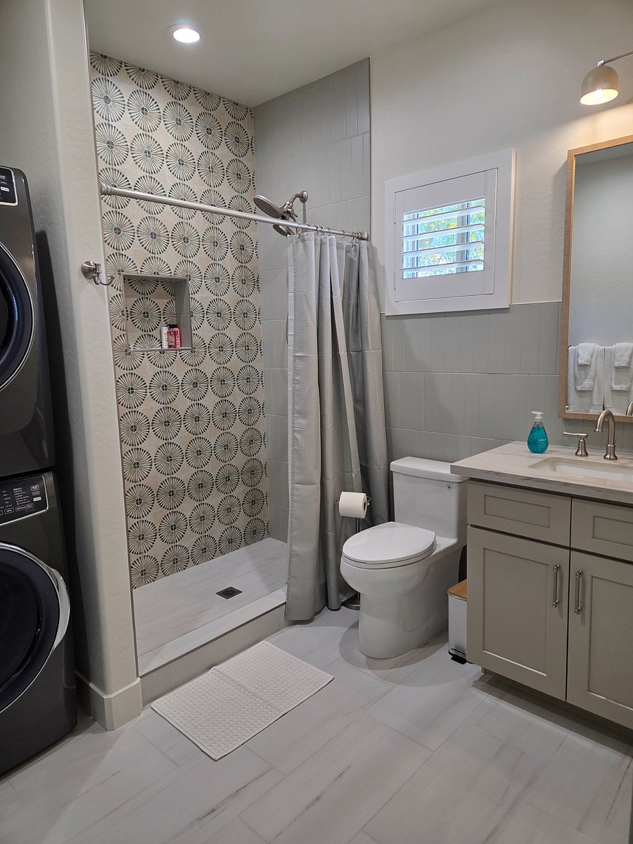 Spacious bathroom featuring a walk-in shower and in-unit laundry.