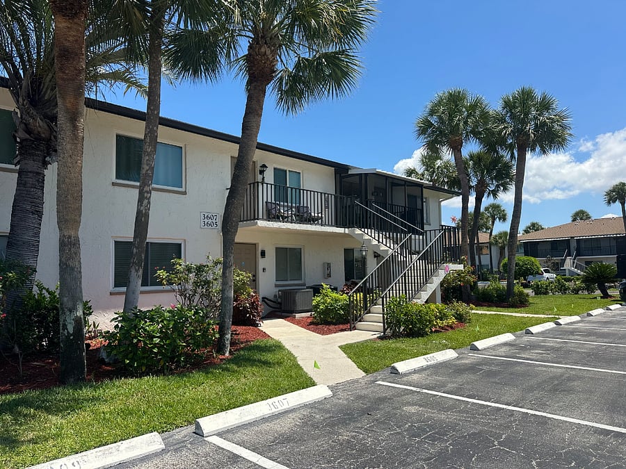 Dedicated parking space and several guest/visitor spaces at the base of the entry stairway