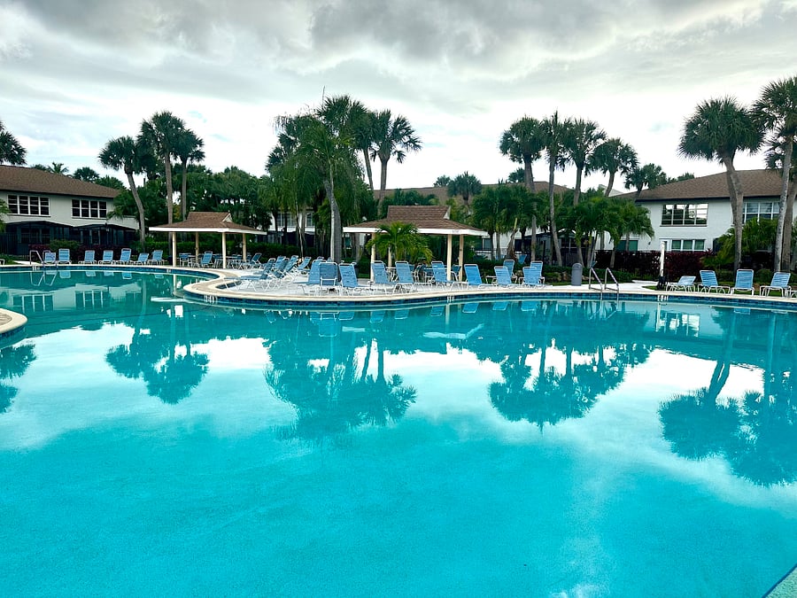 Resort-style pool, cabanas, and lounge areas