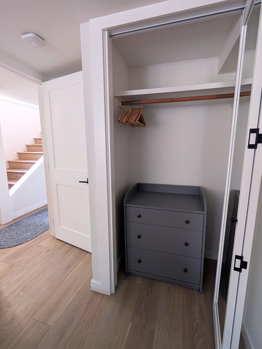 Bedroom closet with dresser and hangers
