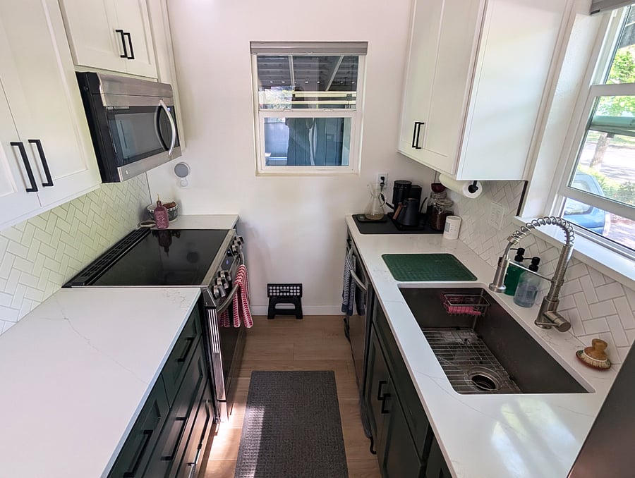 Kitchen with range/oven, microwave, dishwasher and full fridge