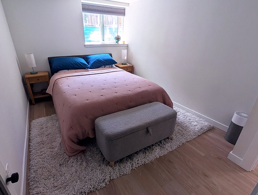 Bedroom with queen bed and storage bench